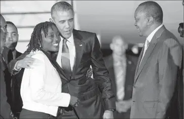  ?? Evan Vucci
Associated Press ?? PRESIDENT OBAMA’S half-sister, Auma Obama, greets him at the airport as Kenyan President Uhuru Kenyatta looks on. Obama appears no longer worried that such a trip might be construed as too personal.