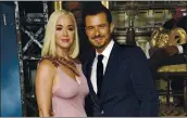  ?? CHRIS PIZZELLO — INVISION/AP ?? Orlando Bloom, right, a cast member in Amazon Prime Video’s “Carnival Row,” with his fiancee, singer Katy Perry, at the 2019 premiere of the series in Los Angeles.