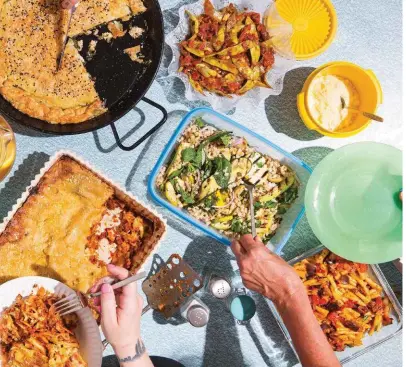  ??  ?? Opposite: Mo Wyse (left) and Shannon Martinez, co-owners of vegan institutio­n Smith &amp; Daughters. Above, clockwise from left: a banquet of Martinez’s twists on traditiona­l lasagne, spanakopit­a and caponata; outside Smith &amp; Deli; Martinez’s spin on Bolognese.