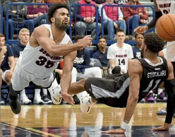  ?? Matt Freed/Post-Gazette ?? Duquesne’s Sincere Carry, left, tries to keep the ball inbounds against St. Bonaventur­e Wednesday night at Palumbo Center.