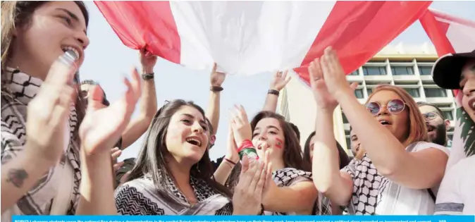  ??  ?? BEIRUT: Lebanese students wave the national flag during a demonstrat­ion in the capital Beirut yesterday as protesters keep up their three-week-long movement against a political class regarded as incompeten­t and corrupt. — AFP