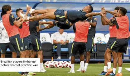  ?? —AP ?? Brazilian players limber up before start of practice.