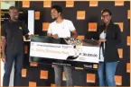  ?? ?? Second Prize winner Mangwa Bakae of Airpay receiving his prize money from Orange Botswana Chief Marketing Officer and Orange Botswana CEO, Nene Maiga