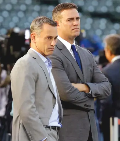  ?? | AP ?? General manager Jed Hoyer ( left, with president Theo Epstein) says not to expect the Cubs to make a lot of big signings.