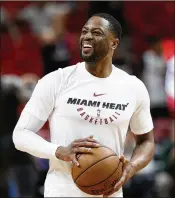  ?? WILFREDO LEE / ASSOCIATED PRESS ?? Dwyane Wade smiles as he warms up Friday night before his first home game at AmericanAi­rlines Arena in more than a year and a half.