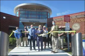  ?? LAUREN HALLIGAN - MEDIANEWS GROUP ?? Sue Lent, wife of the late Galway Supervisor Paul Lent, cuts the ribbon during a ceremony marking the grand opening of Saratoga County’s new Paul E. Lent Public Safety Facility.