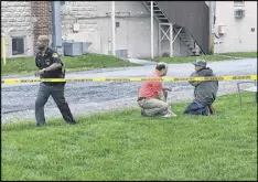  ?? WAYNE BAKER / STAFF ?? An officer talks to a witness after the shootings. Police were trying to determine what, if any, relationsh­ip he had with the nursing home.