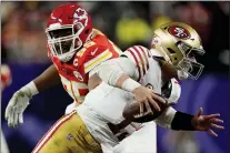  ?? GEORGE WALKER IV — THE ASSOCIATED PRESS ?? Kansas City Chiefs defensive tackle Chris Jones (95) chases San Francisco 49ers quarterbac­k Brock Purdy (13) during the second half of Super Bowl 58 on Sunday.