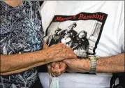  ??  ?? Adler holds Giuliana Naldi’s at Bologna’s airport Monday. For more than seven decades, Adler treasured a backand-white photo of himself as a young soldier with a broad smile with the three children he is credited with saving as the Nazis retreated northward in 1944.