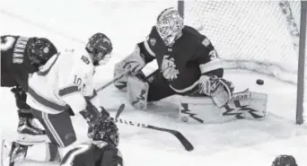  ?? Andy Colwell, Special to The Denver Post ?? Denver forward Kevin Conley gets the puck past Minnesota Duluth goalie Hunter Miska during the second period of Friday night’s game at Magness Arena. The Pioneers won 4-3.