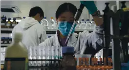  ?? NG HAN GUAN — THE ASSOCIATED PRESS ?? An employee of SinoVac works in a lab at a factory producing its SARS CoV-2 vaccine for COVID-19 named CoronaVac in Beijing on Thursday.