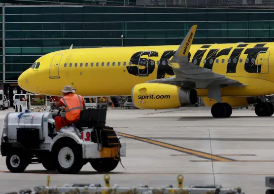  ?? Joe Raedle, Getty Images ?? A Spirit Airlines plane is pushed back from the gate at Miami Internatio­nal Airport on Wednesday. A merger deal between Spirit and Denver-based Frontier Airlines has fallen apart after a bidding war triggered by Jetblue Airways.