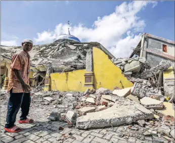  ?? PICTURE: EPA ?? A man inspects a collapsed mosque after an earthquake struck Pidie Jaya in Indonesia’s Aceh province yesterday.