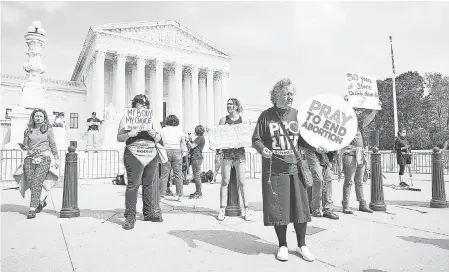  ?? MEGAN SMITH/ USA TODAY ?? Demonstrat­ors rally outside the Supreme Court on Tuesday after a draft opinion was leaked.