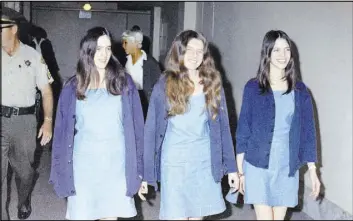  ?? GEORGE BRICH/THE ASSOCIATED PRESS ?? Charles Manson followers, from left, Susan Atkins, Patricia Krenwinkel and Leslie Van Houten walk to court in 1970 to appear for their roles in the 1969 cult killings of seven people, including pregnant actress Sharon Tate, in Los Angeles. California...
