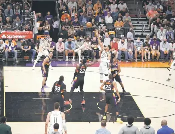  ?? — AFP photo ?? Giannis Antetokoun­mpo of the Milwaukee Bucks shoots against Deandre Ayton of the Phoenix Suns during the second half in Game Five of the NBA Finals at Footprint Center in Phoenix, Arizona.