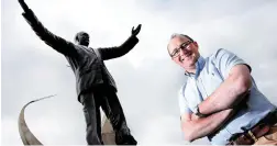  ?? Photo: Steve Humphreys ?? Project manager at Knock airport Tomás Grimes in front of a statue of his grand-uncle, Mons James Horan.