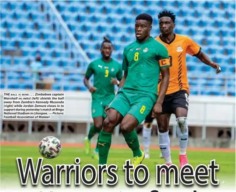  ?? — Picture: Football Associatio­n of Malawi ?? THE BALL IS MINE . . . Zimbabwe captain Marshall MUnetsi (left) shields the ball away from Zambia’s Kennedy Musonda (right) while Jordan Zemura closes in to support during yesterday’s match at Bingu National Stadium in Lilongwe.