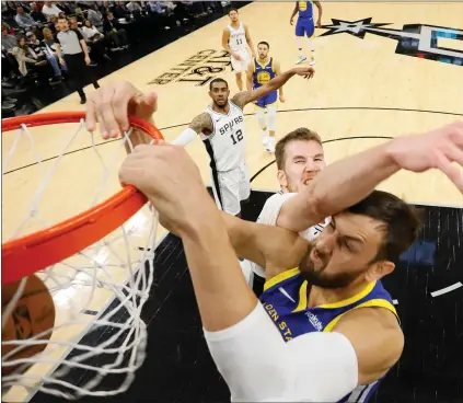  ?? SOOBUM IM — USA TODAY SPORTS ?? Andrew Bogut, in his first NBA game in nearly a year, dunks over the Spurs’ Jakob Poeltl on Monday. He had seven points and seven rebounds.