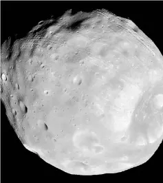  ?? — Reuters photo ?? Phobos, the largest of Mar’s two moons, taken by the high resolution Imaging Science Experiment (HiRISE) camera on NASA’s Mars Reconnaiss­ance Orbiter.