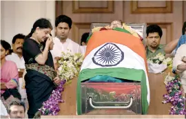  ??  ?? Sasikala wipes her tears as she stands next to the coffin of Tamil Nadu Chief Minister Jayalalith­aa Jayaram at Rajaji hall in Chennai on December 6, 2016. AFP