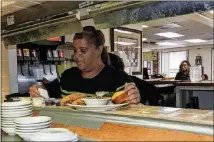 ?? JAY JONES/CHICAGO TRIBUNE/TNS ?? The Four Way owner Patrice Thompson checks on orders during the Sunday lunchtime rush at her restaurant in Memphis. Thompson said King routinely stopped by for soul food when he was in town.