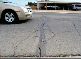  ?? Buy this photo at YumaSun.com PHOTO BY CESAR NEYOY/BAJO EL SOL ?? CRACKS STRETCH ACROSS Merrill Avenue, a westside street in San Luis the city plans to repave later this year.