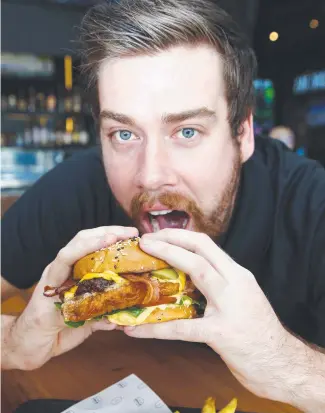  ?? Picture: Tertius Pickard ?? Venue manager Jackson Carman prepares for World Burger Day at The Sporting Globe in Robina.