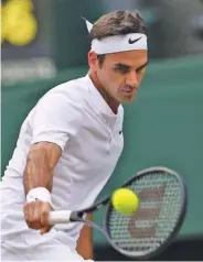  ?? THE ASSOCIATED PRESS ?? Switzerlan­d’s Roger Federer returns a backhand to Germany’s Mischa Zverev during Saturday’s men’s singles match at Wimbledon.