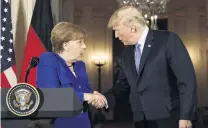  ?? PHOTO: REUTERS ?? Shake on it . . . US President Donald Trump greets Germany’s Chancellor Angela Merkel during a joint news conference in the East Room of the White House in Washington on Saturday.
