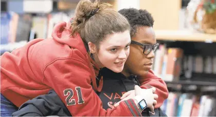  ?? PHOTOS BY DAVID GARRETT/SPECIAL TO THE MORNING CALL ?? Quakertown High juniors Alexis Kosh and Jolly Ekpe share a moment in the school library. Ekpe said he was angry when he heard about a group of middle schoolers’ racist actions at a 2017 football game against Cheltenham High.