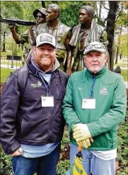  ?? CONTRIBUTE­D ?? Wright State assistant women’s softball coach Dave Brittingha­m and his son, Josh, an Iraq War vet, stand in front of the Three Servicemen memorial.