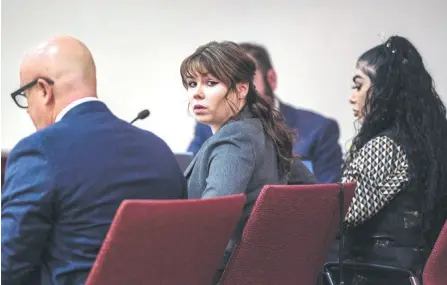  ?? — AFP photo ?? Gutierrez (centre) sits with her aŽorney Jason Bowles, le’, during the first day of testimony in the trial against her at First Judicial District Courthouse in Santa Fe, New Mexico.