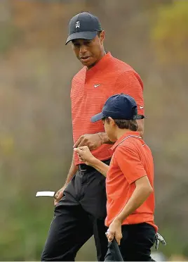  ?? Picture: AFP ?? BETTER TIMES. Tiger Woods fist-bumps his son Charlie at the Ritz Carlton Golf Club in Orlando, Florida in December last year.