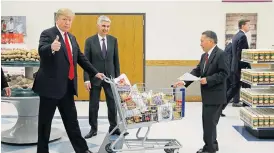  ?? /Reuters ?? Another happy customer: US President Donald Trump pushes a shopping trolley in Utah in December 2017. Consumer optimism remains elevated amid a tight labour market and lower taxes.