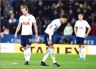  ?? OLI SCARFF/AFP ?? Tottenham Hotspur’s striker Harry Kane (left) and midfielder Dele Alli react after Leicester score their second goal during their Premier League match at the King Power Stadium in Leicester on Tuesday.