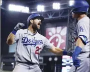  ?? AP photo ?? The Dodgers’ Steven Souza celebrates his home run with Andy Burns during the eighth inning Friday.