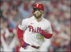  ?? Associated Press ?? The Phillies’ Bryce Harper celebrates his two-run home run during the first inning in Game 3 of the World Series against the Houston Astros, Nov. 1, in Philadelph­ia. The Phillies’ slugger is recovering from offseason elbow surgery.