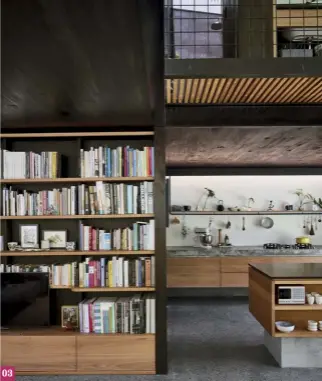  ??  ?? 03 04 The concrete benchtop runs the length of the kitchen. Appliances are hidden from view for a cohesive aesthetic. 05 An open timber shelf supported by steel rods hangs above the bench and provides storage for everyday items.