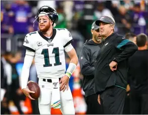  ?? ASSOCIATED PRESS FILE ?? Carson Wentz, left, and Eagles coach Doug Pederson know they have an uphill struggle this season if they plan on a return to the playoffs.