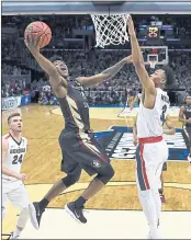  ?? JAE HONG – THE ASSOCIATED PRESS ?? Florida State’s TeranceMan­n, left, shoots against Gonzaga’s Johnathan Williams during Thursday’s game.