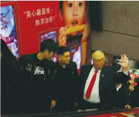  ?? (Bobby Yip/Reuters) ?? TRUMP IMPERSONAT­OR Dennis Alan, 66, of Chicago, greets people inside a subway station in Hong Kong on January 25. Until now, the real US president had been largely silent on what he would like to accomplish in relations with China.