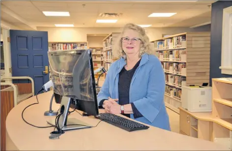  ?? LAWRENCE POWELL ?? Librarian Dorothy MacDonald at the front counter of the new Annapolis Royal Library that recently opened at The Academy. The spacious location is warm and cozy. Staff moved to the new spot from the old location at town hall.