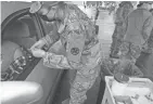  ?? SGT. 1ST CLASS THOMAS VEGA/OHIO NATIONAL GUARD ?? Ohio Army National Guard Spc. Amanda Heckman prepares to administer a COVID-19 vaccine. Gov. Mike Dewine deployed the Guard to assist with staffing shortages.