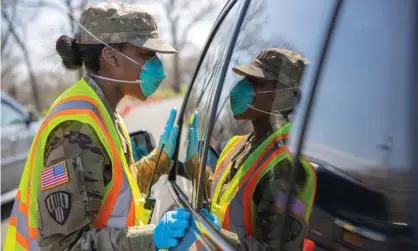  ?? Photograph: Sgt Jonathan Pietranton­i/National guard/Handout/EPA ?? A national guard member at a Covid-19 testing center in New Rochelle, New York, earlier this month.