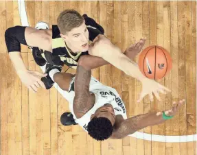  ?? MIKE CARTER/USA TODAY SPORTS ?? Purdue center Isaac Haas, top, blocks a shot by Michigan State forward Nick Ward.