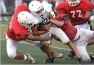  ?? RECORDER PHOTO BY CHIEKO HARA ?? Lindsay High School’s Eduardo Delgado, left, and Noah Hunter tackle Portervill­e High School runner (4) during a scrimmage at Frank Skadan Stadium in Lindsay.