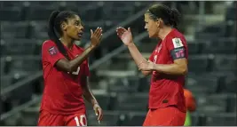  ?? FERNANDO LLANO — THE ASSOCIATED PRESS ?? Canada's Christine Sinclair, right, is congratula­ted by Ashley Lawrence after scoring against Trinidad and Tobago. Sinclair says the team is focused on its match against the U.S.