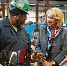  ?? Mark Mulligan / Staff photograph­er ?? U.S. Education Secretary Betsy DeVos talks with Jamal Truley at the S&B’s training center in Baytown.