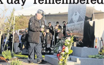  ?? PHOTOS BY OLIVIA MALLEY ?? Men of the Deeps lay white roses, one for each person killed in the Westray Mine Disaster.